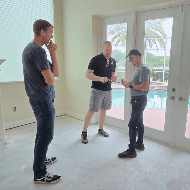 A team discusses a Steller Solid Wood Floors Install Over Concrete in Florida