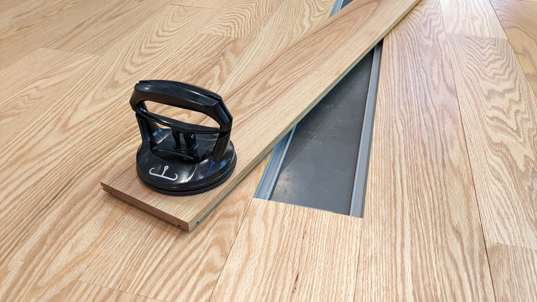Snap-together hardwood flooring installation over concrete slab.
