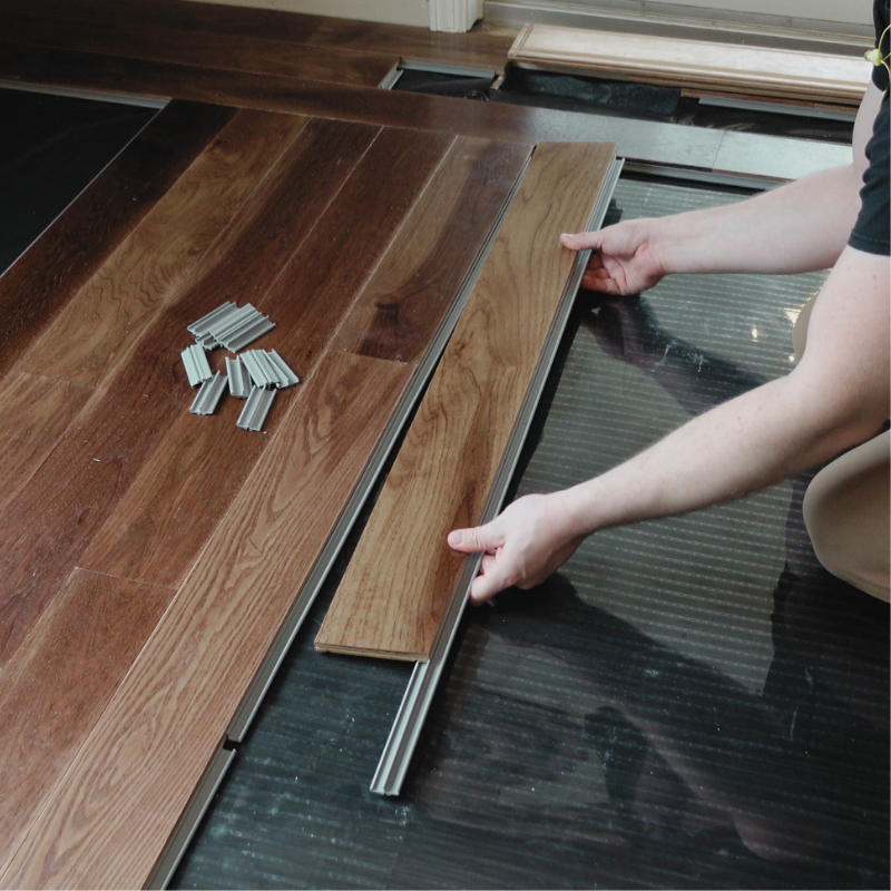 A Steller solid wood floor is installed over a subfloor heat system
