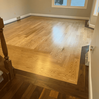Steller Floating Solid Wood Floors in DIY Renovations - Tahoe Walnut Picture Frame Border with American Oak Tacoma - Craftsmanship - Matching Banister
