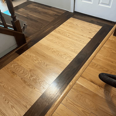 Steller Floating Solid Wood Floors in DIY Renovations - Tahoe Walnut Picture Frame Border with American Oak Tacoma - Craftsmanship - Decorative Hallway