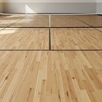 Indoor pickleball court with wooden floor and net setup